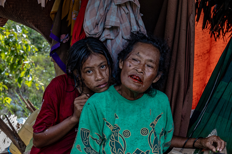 Hoyu Tatilegan, 60, and her daughter, member of the O Hongana Manyawa ethnic group (commonly referred to by outsiders as the Togutil or Tobelo Dalam people), were photographed near Fetealu River, East Halmahera on August 18, 2024.